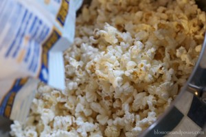 pour popcorn into pan - Blossoms and Posies