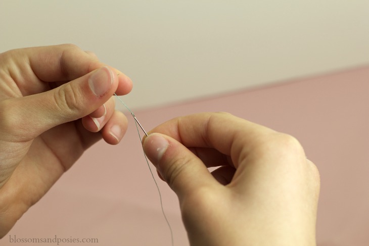 Pull thread throguh needle