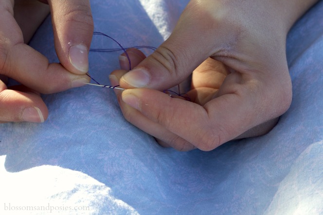 Threading a needle and tying a knot - yarn 