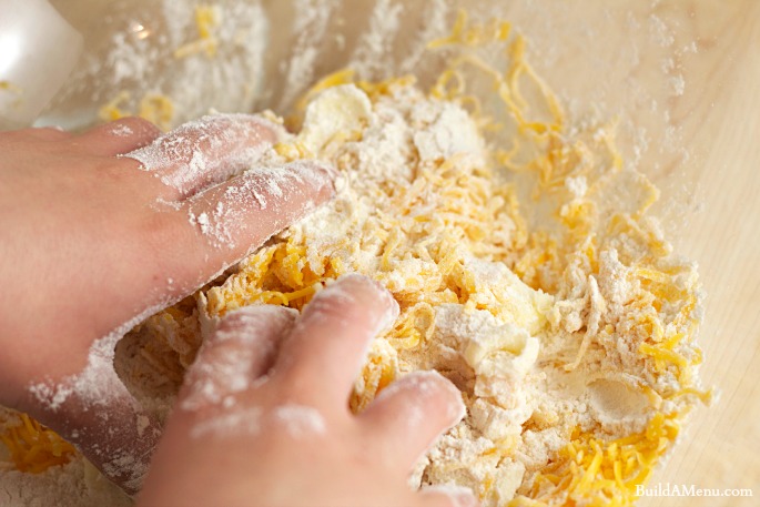 mix dough with hands - BlossomsAndPosies.com